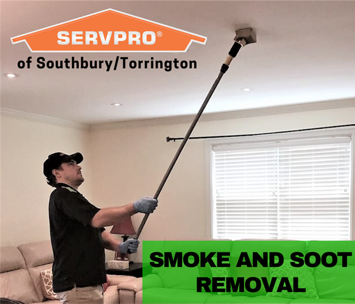 SERVPRO employee cleaning a ceiling