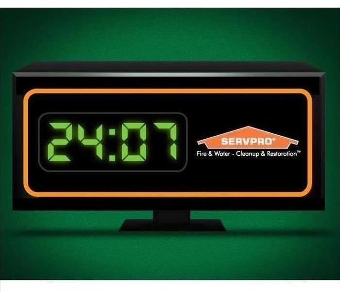 Digital clock with servpro logo with time at 24:07